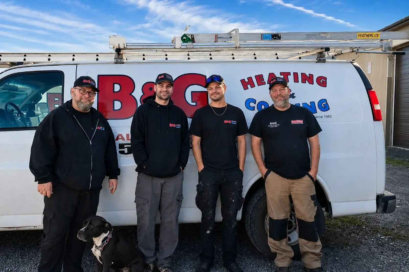 The B & G Heating & Cooling family team in front of their service van in Hamilton